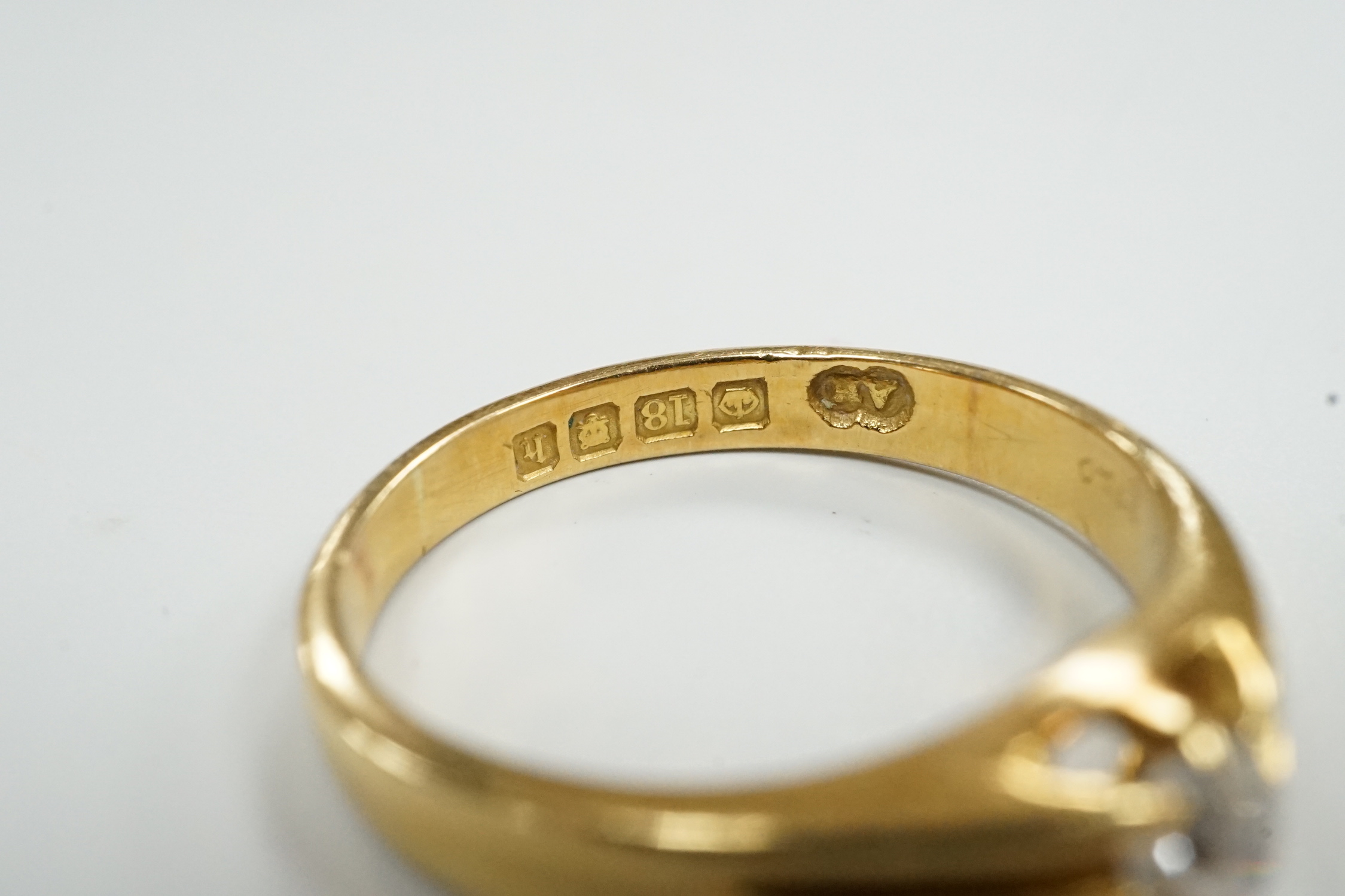 A George V 18ct gold and claw set solitaire diamond ring, size R, gross weight 5.1 grams.